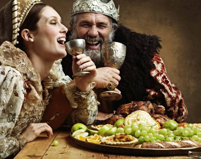 Mead and merriment. A mature king feasting alone over great easy mead recipe in a banquet hall.